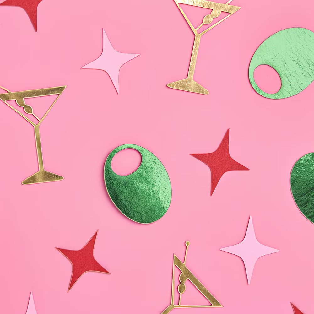 Decorative cutouts of cocktail glasses, stars, and circles on a pink background